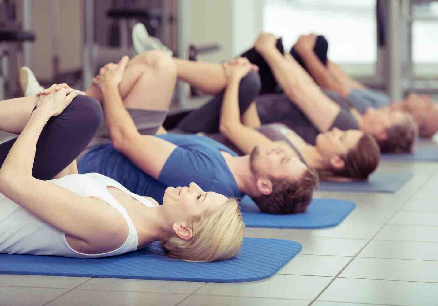 Group of people gentle yoga stretching.